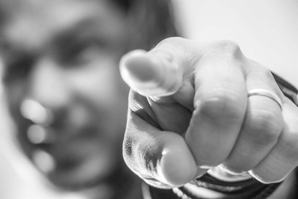 Angry person pointing their finger at you
